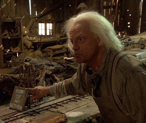 Point of no return Doc Brown pointing at a sign in a miniature model that says "Point of no return"
